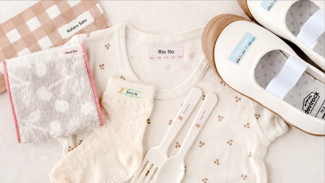 No-iron fabric labels applied to towels, clothing, socks, utensils, and shoes